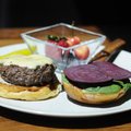 The wagyu burger at Hjem Restaurant, made from extrahigh-grade beef, is served with beet slices, hou...