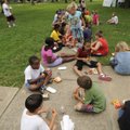 COMMUNITY TREATS - Children enjoy hot dogs and ice cream Friday during a picnic hosted by the Fayett...