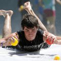 Warren Davis, 15, from Grace Baptist Church of Camden, glides across a water slide Tuesday while com...
