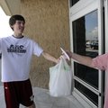Alex Scharlau, 15, honks a horn Friday to celebrate a donation of school supplies from Carlene Under...