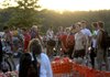 Competitors gather in the transition area shortly after sunrise waiting to begin the Shark Fest IV Triathlon at Horseshoe Bend Park on Sunday at Beaver Lake. The winner of the Olympic Distance men’s division, Maxwell Sawyer, No. 16, stands shirtless at right.