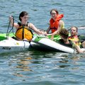 Kayakers Rae Marie Donaldson, from left, and Emily Spunaugle rig a towline Monday for slower rafters...