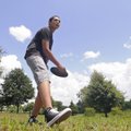 Travis Thornton, 15, throws a flying disc to his father Ray Thornton of Fayetteville on Monday at Gu...