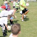 A group of 7 and 8-year-olds learn soccer basics Tuesday from NWA Lightning coach Chris Michael duri...