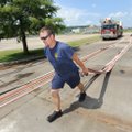 Rookie firefighter Matt Daniels with the Fayetteville Fire Department pulls fire hoses Tuesday befor...