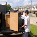 Jesus Soto, 18, loads furniture Wednesday for storage for his family and a neighbor while they vacat...