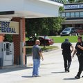 Fayetteville Police Department personnel work at the First Federal Bank location at 3460 N. College ...