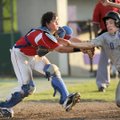 Baytown (Texas) Knights catcher Robert Russell, left, applies the tag to Fayetteville’s Carson Shadd...