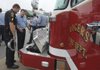 FILE — Captain Scot Mason, right, with the Rogers Fire Department, shows his brother Jarod Mason, with the Rogers Police Department, the extrication tools in the front bumper of Rescue 5 before a dedication ceremony two new trucks at Station 1 in Rogers on Friday, July 9, 2010.