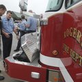 FILE — Captain Scot Mason, right, with the Rogers Fire Department, shows his brother Jarod Mason, wi...