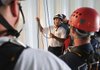 Rick Portilloz of Sand Springs, Okla., talks Wednesday with Rogers firefighters while training for a rope rescue inside a Rogers water tower. Portilloz said rope rescues are rare but when needed are high risk and need to be performed by well-trained personnel.