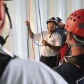 Rick Portilloz of Sand Springs, Okla., talks Wednesday with Rogers firefighters while training for a...