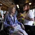 Judy Terry, left, sits Wednesday with daughter-in-law Cheran Main as she rides the Arkansas & Missou...