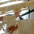 Taylor Neff, 12, hangs fresh spaghetti to dry Thursday to prepare for Tontitown's Spaghetti Dinner d...