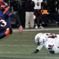 Rogers Heritage quarterback Reed Brown runs through the tackle of Springdale High’s Blake Griffith t...
