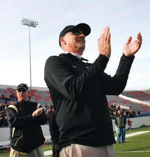 Bentonville coach Barry Lunney applauds his Tigers after defeating Fort Smith Southside in the Class 7A State Championship Game on Dec. 6, 2008, in War Memorial Stadium in Little Rock.
