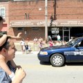 EVERYONE LOVES A PARADE - Karla Hernandez, 2, welcomes the Centerton Day Parade on Saturday from her...