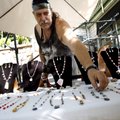 Alan Flucard spreads out jewelry Saturday on the table he operates with his wife, Kay Goacher, both ...