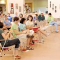 Kristina Jones, a member of the Fayetteville Community Garden Coalition Committee, right, leads a di...