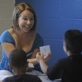 Heather Bowen plays a word game with children Wednesday during a reading program called Leap Ahead. ...