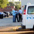 Police Officers investigate the robbery of an armored car Monday, Aug. 2, 2010, in St. Louis' theate...