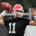 University of Georgia starting quarterback Aaron Murray throws a pass on the first day of football p...