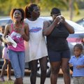 A family reacts as Shreveport Fire Department and Caddo Sheriff's deputies scour the beach at Charle...