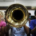 Samantha Jordan, from left, Zurisanai Zuniga and Jose Aguilar play their horns Monday during the fir...