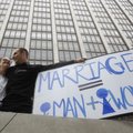 Nadia Chayka, left, and her fiance Luke Otterstad, both proponents of Proposition 8, hold up a sign ...