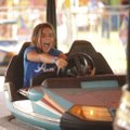 Celine Prelle, 11, of Decatur laughs Tuesday while chasing her sister and family while taking their ...