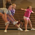 Rebecca Byers, 9, left, joins other participants Tuesday in exercises during Cheer Camp at the Roger...