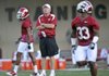 Arkansas Coach Bobby Petrino watches Dennis Johnson (33) during early drills in the Razorbacks’ first practice Thursday in Fayetteville.