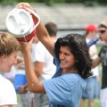 COOL-HEADED - Fayetteville High School senior Saba Kouchehbagh, right, pours water on the head of fe...