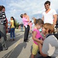A MOMENT WITH MOMMY - Parents Joy and Wesley Northey give a last-minute goodbye hug Thursday to thei...