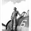 “South Pacific” — Lt. Charles Johns stands on the wing of his F6F Hellcat at Orote Air Field on Guam...