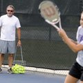 Rogers High tennis coach Ronny Cowan watches his team at practice Thursday at Rogers High.
