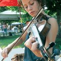 MARKETABLE TALENT - Music instructor Lorie Morris plays the violin Saturuday on Bentonville Square d...