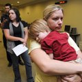 Linda Duncan of Fayetteville holds her son, Bentley Boldman, 2, while waiting in line at NorthWest A...