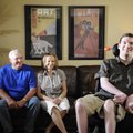 Ryan Sutton, right, sits for a portrait with his parents, Wayne and Dyann, at his home in Springdale...