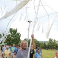 Hank Kaminsky holds a peace crane while leading a procession to the Fulbright Peace Fountain for the...