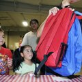 Adrian Becerra, from left, and his sisters Daniella and Fernanda receive their new backpacks Monday ...