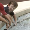 Charlie Sagely, 5, left, and Hudson Tarp, 3, cool off Monday in the fountain on the Bentonville squa...