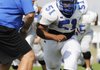 Rogers High’s Lorenzo Gentry runs through a drill Monday.