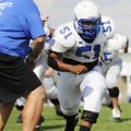 Rogers High’s Lorenzo Gentry runs through a drill Monday.