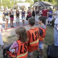 Second-grade teacher Ginger Stegall, left, and Bill Wendell talk Tuesday to a group of parent volunt...