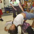 Kassie Misiewizc with Trike Theater in Bentonville works Tuesday with students contorting into vario...