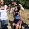 NEW HOME IN THE FUTURE - Cinthya Sanchez, 9, is embraced by her brother, Gustavo, as her mother Nere...