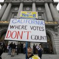 Victor Choban of Sacramento, Calif., holds up a sign outside City Hall as some same-sex couples line...