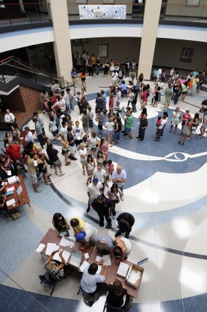 Har-Ber High School sophomores and their families line up Thursday to get their class schedules for the new school year at the school in Springdale. Hundreds of students arrived to get schedules, photo IDs, pay fines and fees and get locker assignments.
