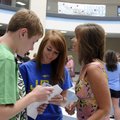 Carter Henson, 15, from left, shows his class schedule to his sister, Morgan Henson, and mother, San...